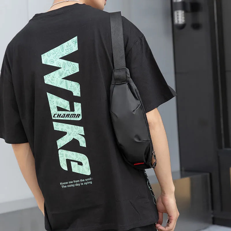 Black oxford cloth tactical crossbody bag showing front zipper and compact size.