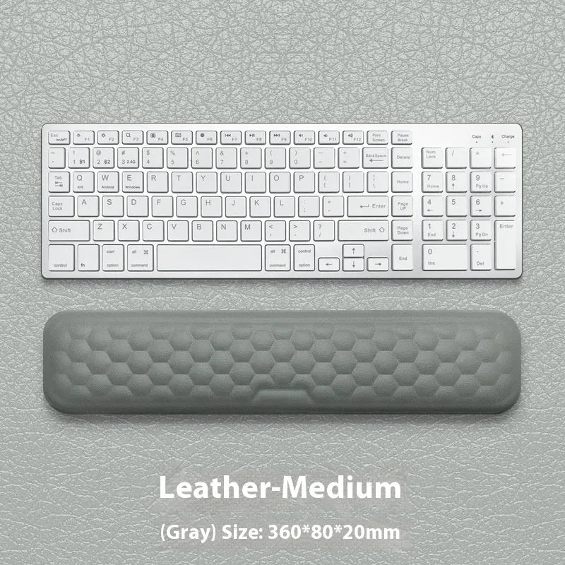 Memory foam mouse wrist pad with silicone bottom in black cloth cover on computer desk