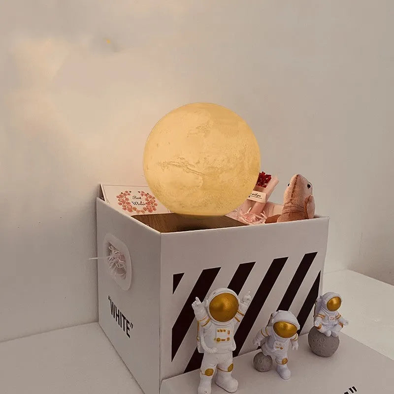 Maglev Moon Earth planet night light floating above base with LED glow, next to astronaut figurines.