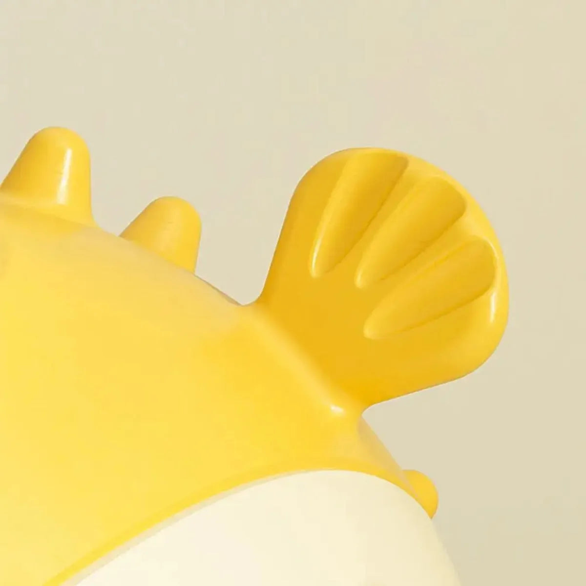 Yellow vinyl fish-shaped dog chew toy with textured surface for aggressive chewers.