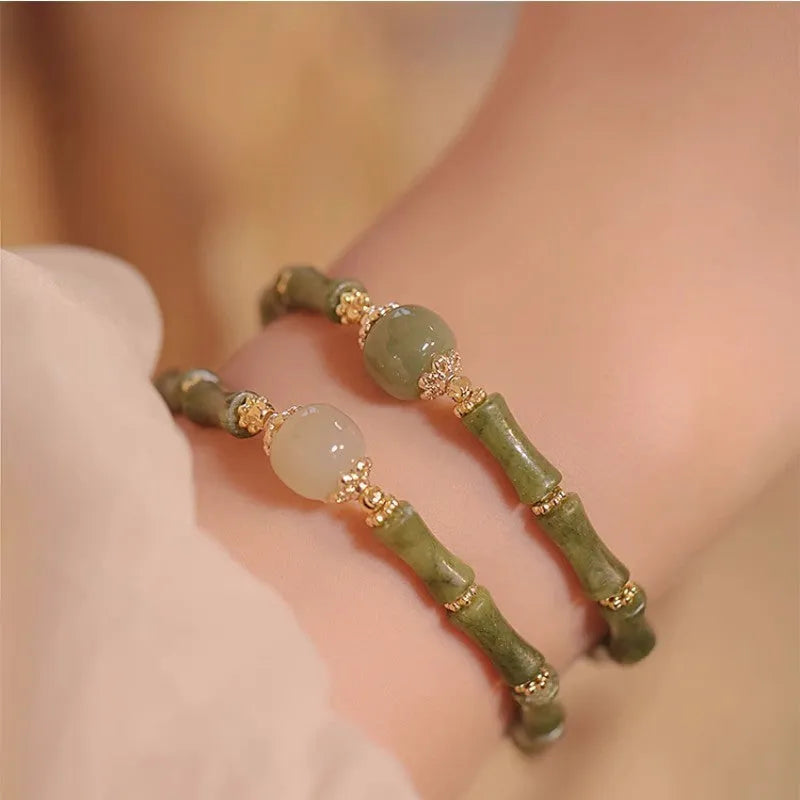 Dark green Hetian jade bracelet with geometric bamboo festival design on wrist