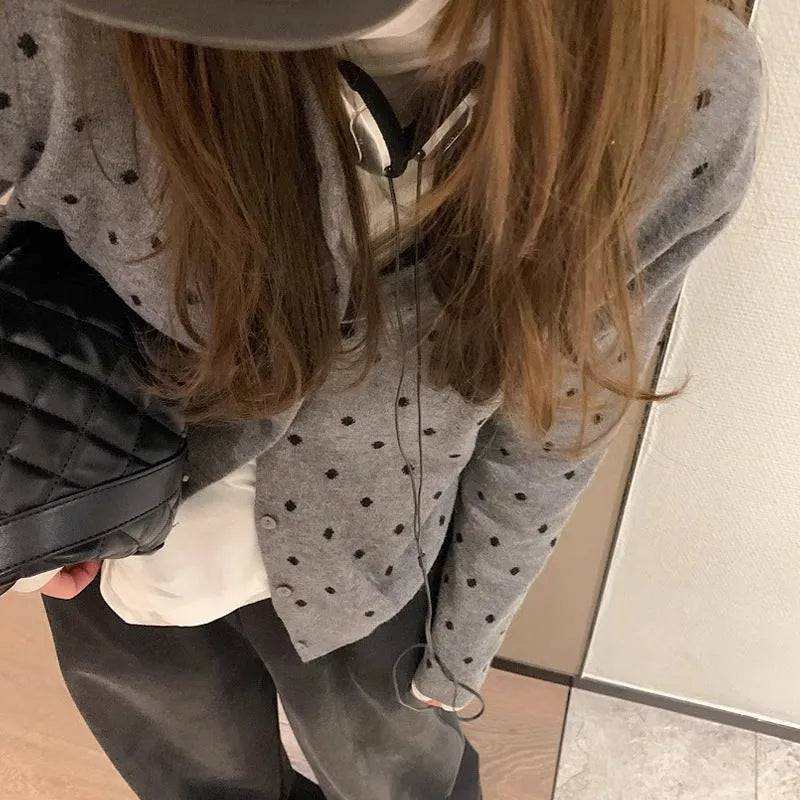 Women's grey dot knitted cardigan with long sleeves and crocheted flower detail