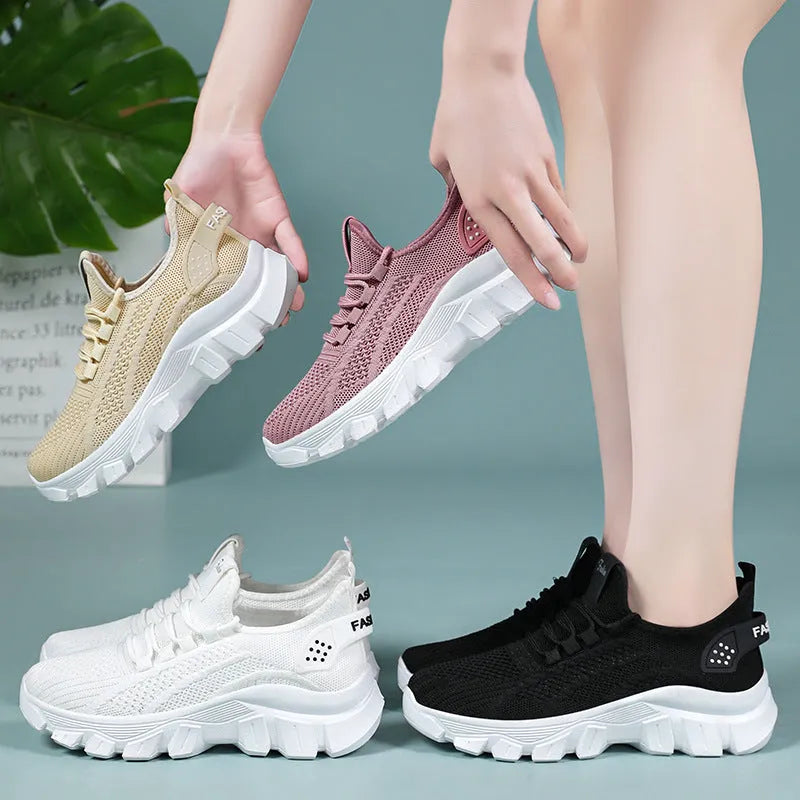 Women's white Flyknit running sneakers with a thick PVC sole and lace-up front.
