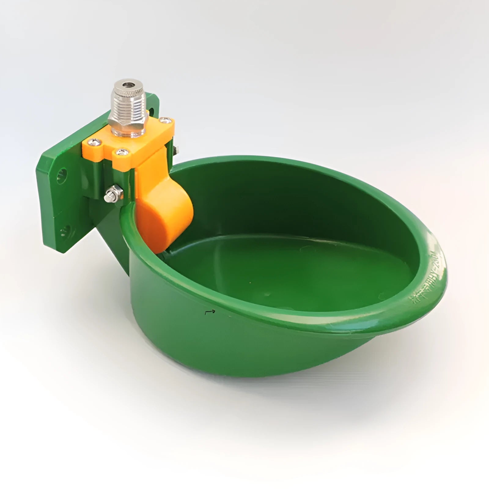 Green engineering plastic auto-drink water bowl for pigs and sheep on a farm.