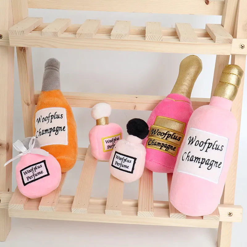 Soft plush pet toy shaped like a wine bottle, shown in various colours including green, red, and black.