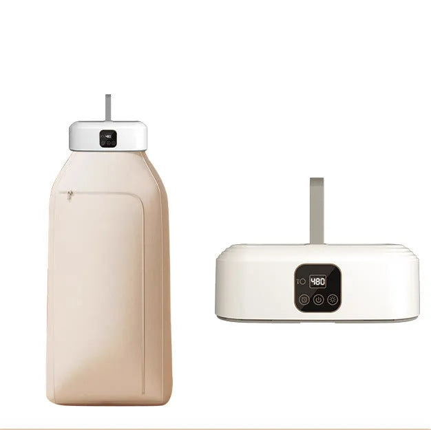 White cylindrical compact laundry dryer with remote control on countertop