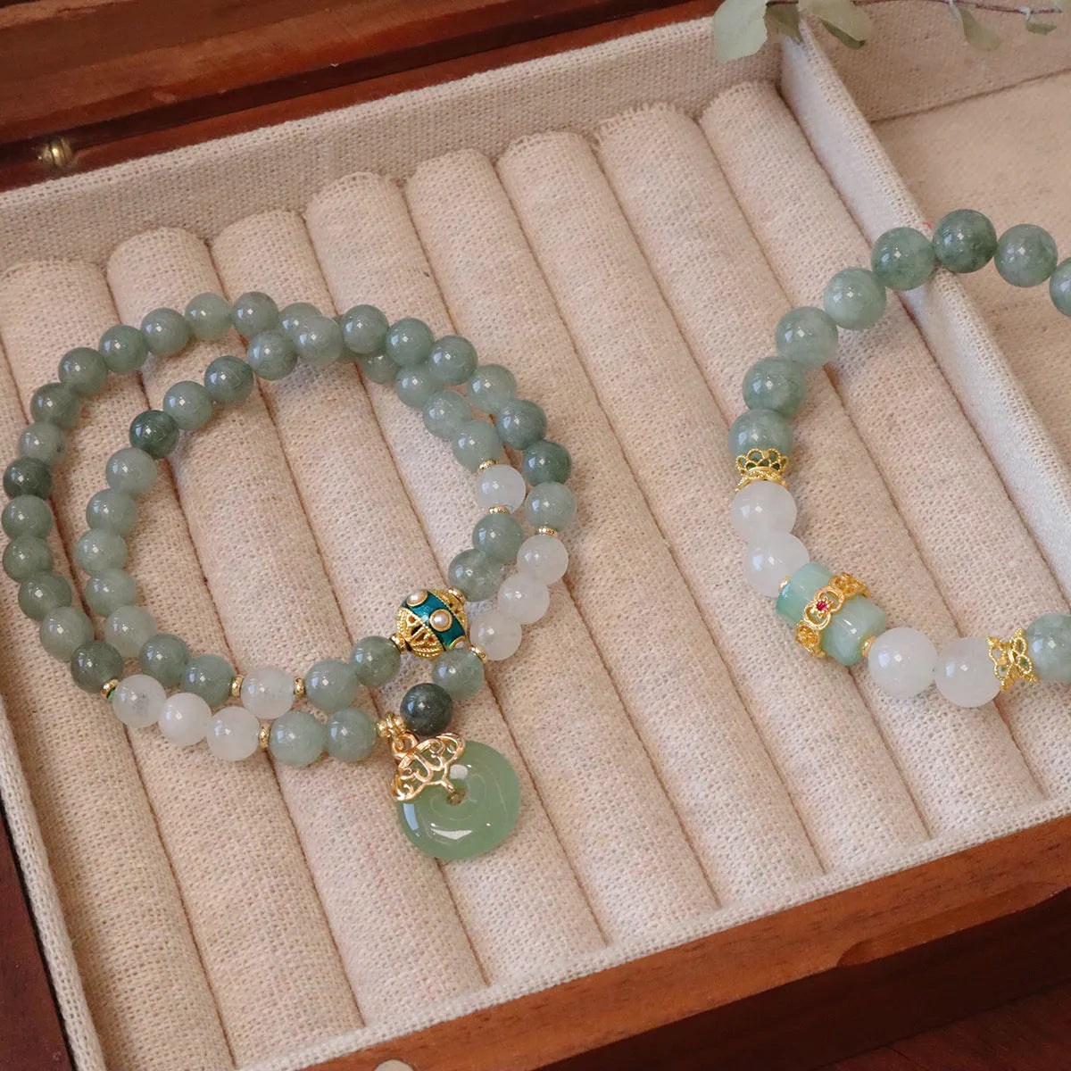 Women's bracelet with a Myanmar jade safety buckle pendant and lucky beads on a geometric crystal band.
