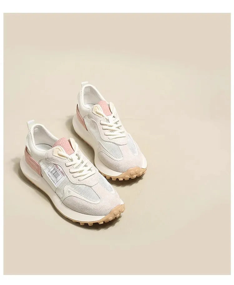 Women's grey and pink retro low-top sneaker with round toe and rubber sole.