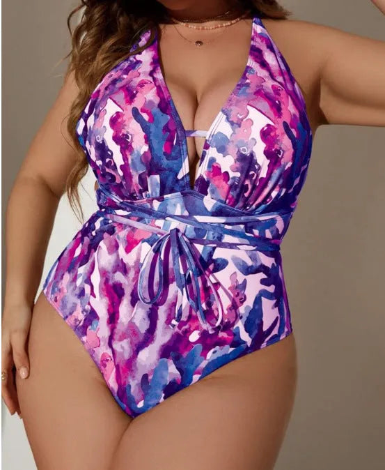 Women's solid colour halter neck one-piece swimsuit on a hanger, available in purple or blue.