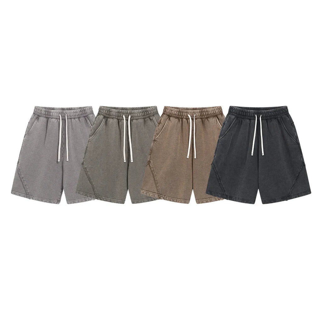 Man wearing loose-fit batik washed cotton terry shorts in a retro style with patch craft details.