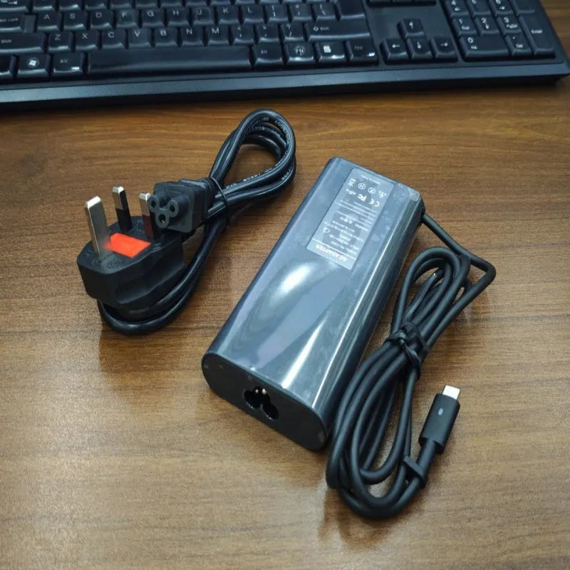 Black oval 65W laptop Type-C charger with six interchangeable international power cords