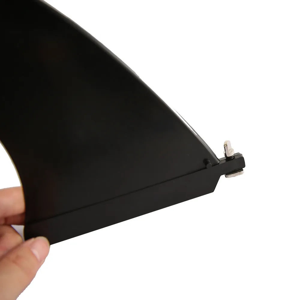 SUP paddle with large removable plastic fish fins attached via screw mechanism.