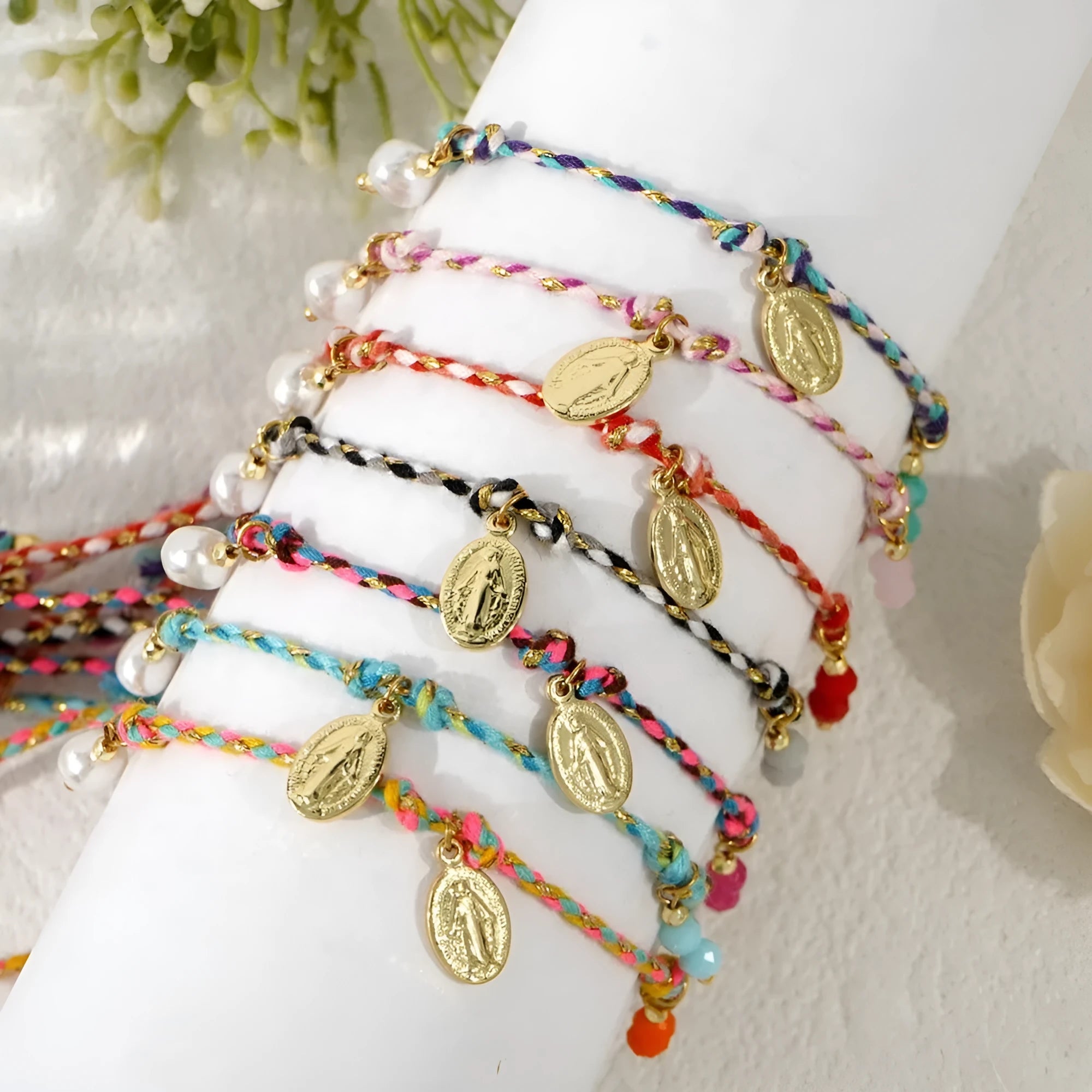 Close-up of a hand-woven colourful braided rope bracelet for women featuring an adjustable carrying strap tag closure.