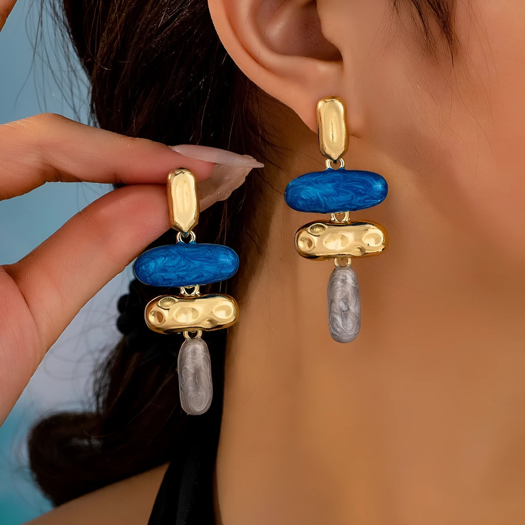 Geometric multicolor stud earrings for women with electroplated finish and simple design.