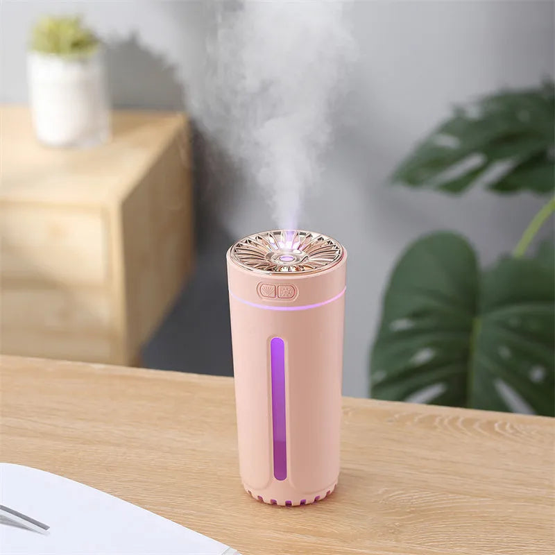 Black portable USB humidifier with colourful LED lights, shown next to a USB cable, suitable for car cup holders.