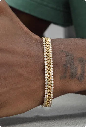 Gold-coloured titanium steel tennis bracelet with inlaid artificial gemstones on a wrist.