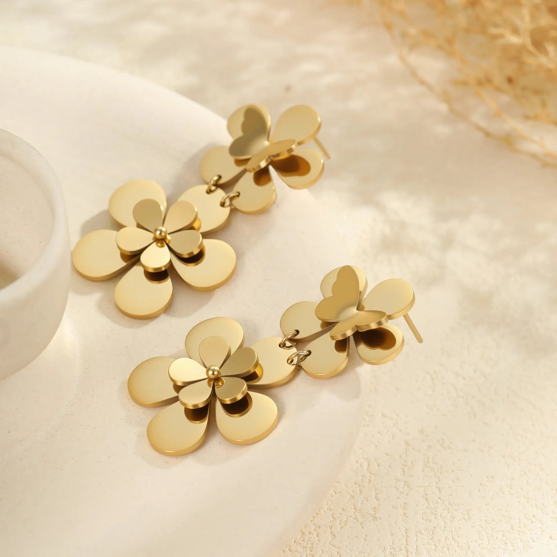 Women's stainless steel earrings with gold electroplated finish and floral butterfly design