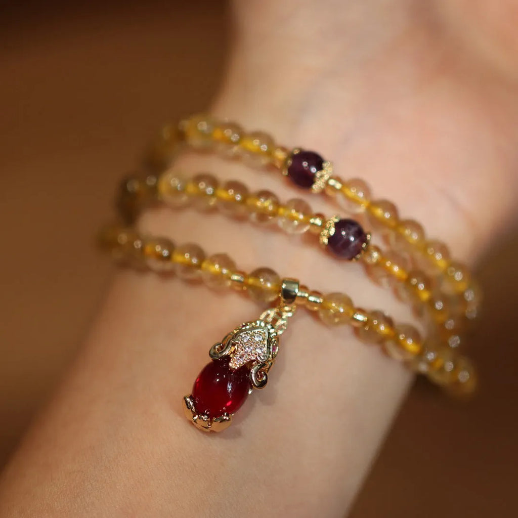 Natural Brazilian gold rutilated quartz bracelet with three-circle gold and ruby quartz design
