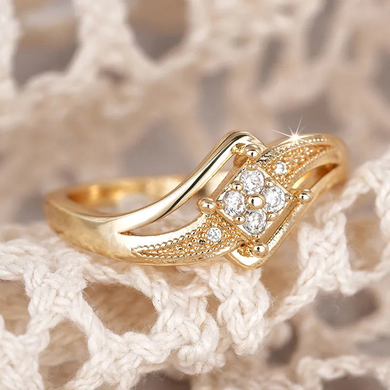 Diamond-shaped yellow gold tone copper ring with micro-inlaid zircon stones on finger