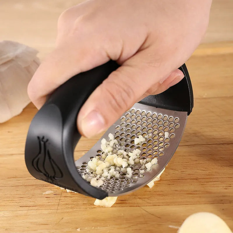 304 stainless steel garlic press in modern design with 11cm by 7cm dimensions