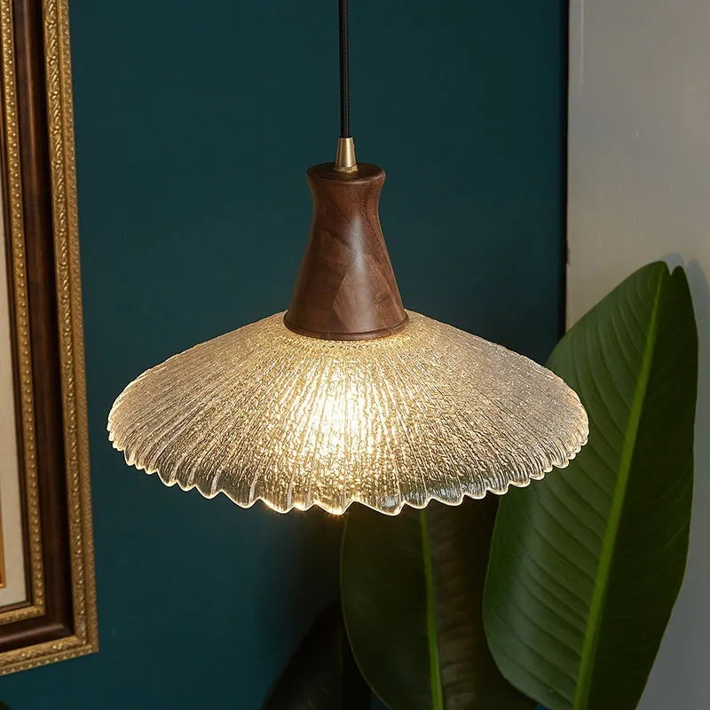 Retro wood and brass chandelier with glass shade in three size options for ceiling mounting.