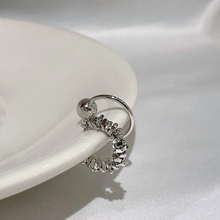 A pair of silver-toned geometric clip-on earrings with an irregular frosty finish and double drop design.