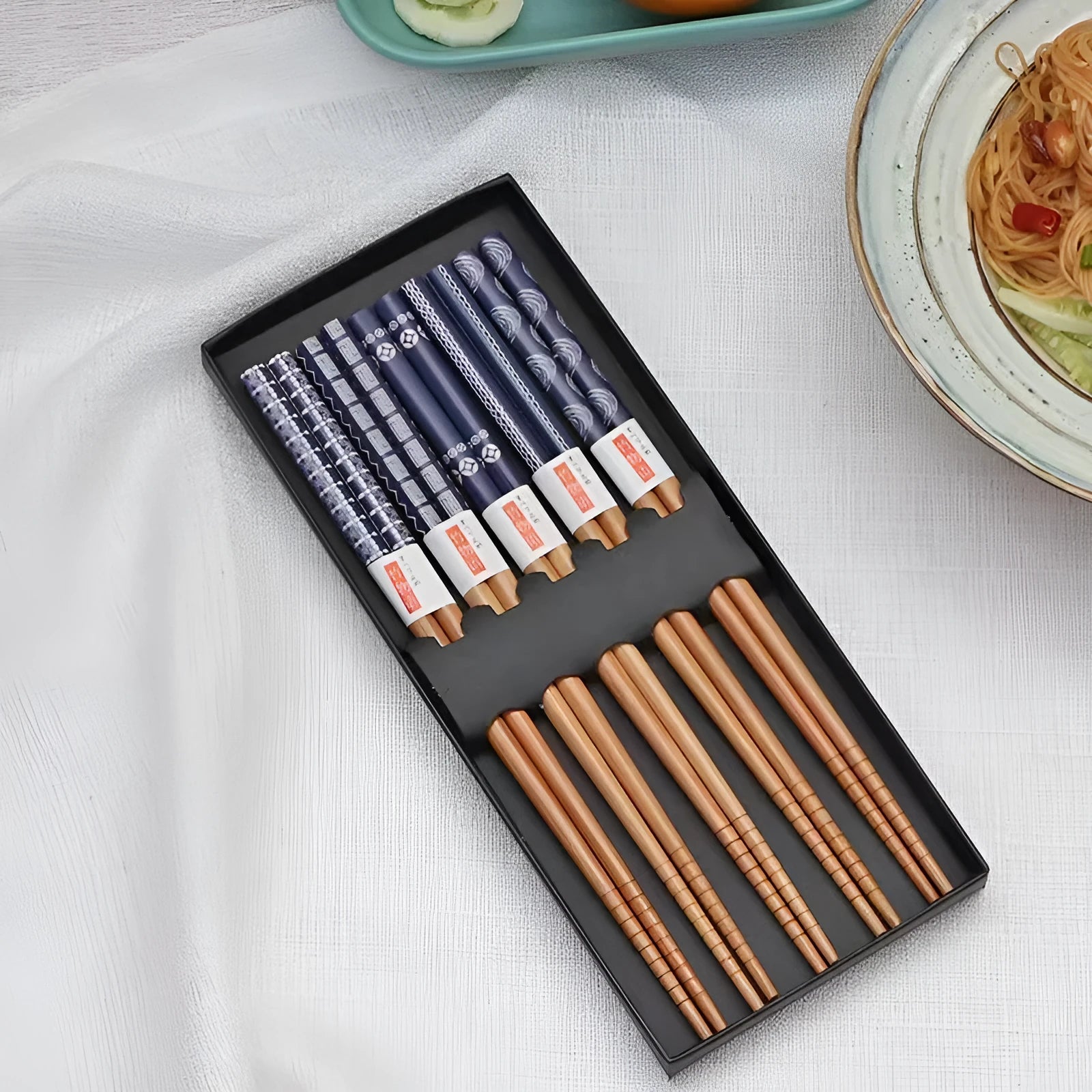 Set of five pairs of bamboo chopsticks with Japanese cartoon pattern in a gift box.