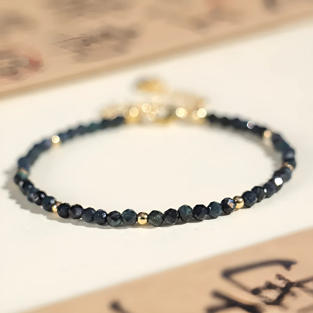 Blue tourmaline bracelet with 3mm cut beads and spacer bead design