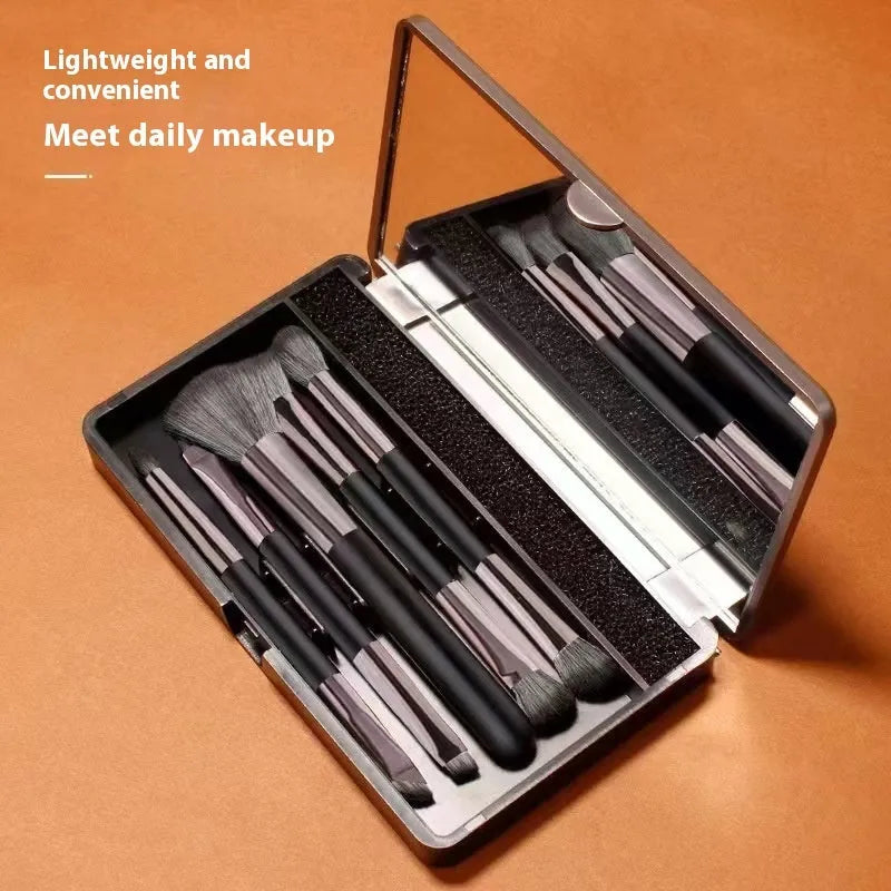 Portable makeup brush set with mirror showing 4 or 5 eyeshadow brushes with artificial fibre bristles