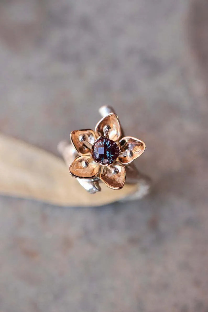 Silver two-tone floral geometric women's alloy ring shown on a finger, demonstrating its design and fit.