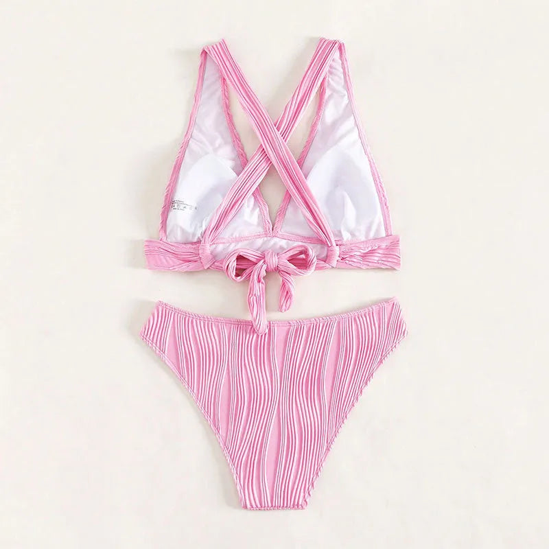 Women's pink halter strap bikini set with matching shorts on mannequin