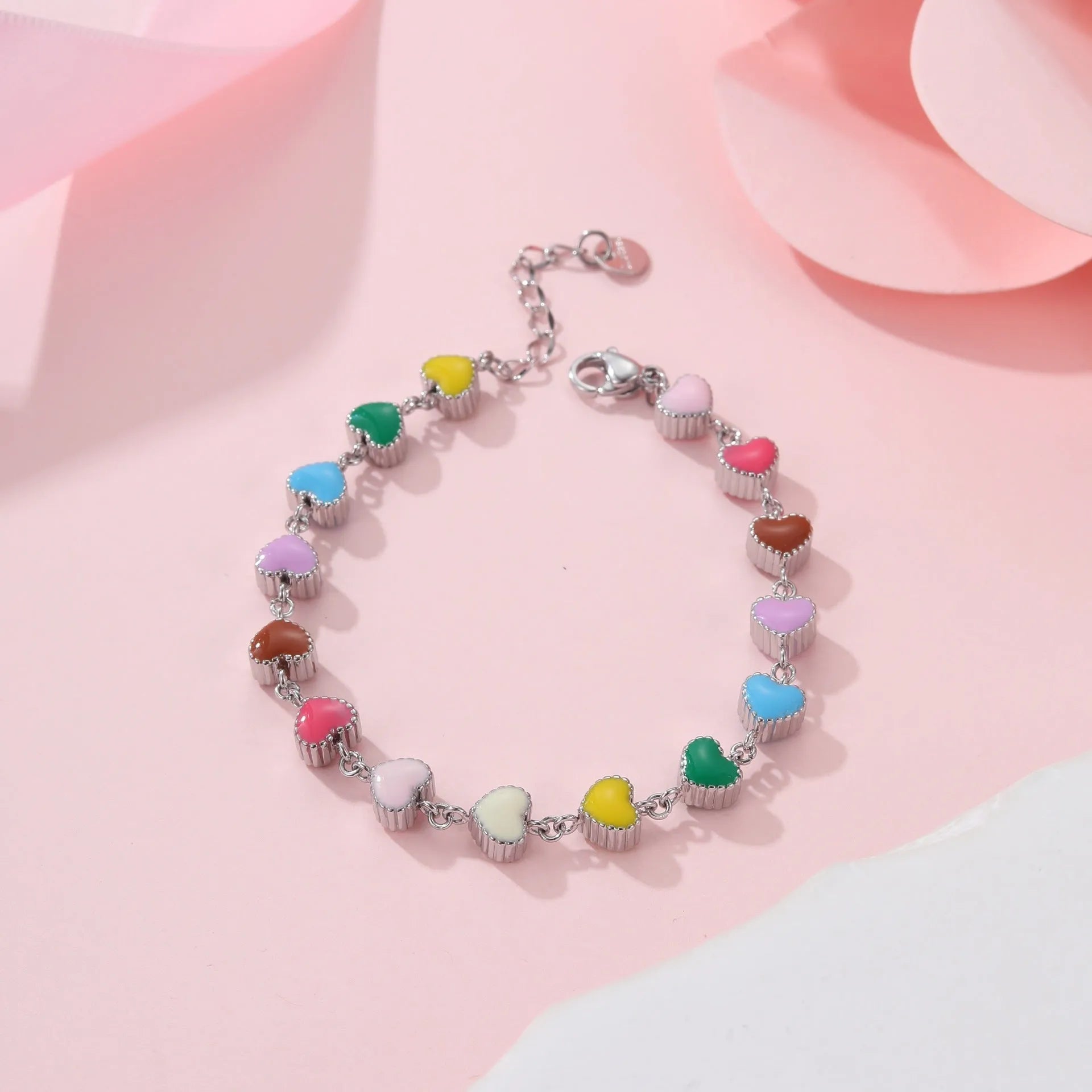 Women's stainless steel bracelet with love heart pendant featuring colourful oil finish in gold or steel colour
