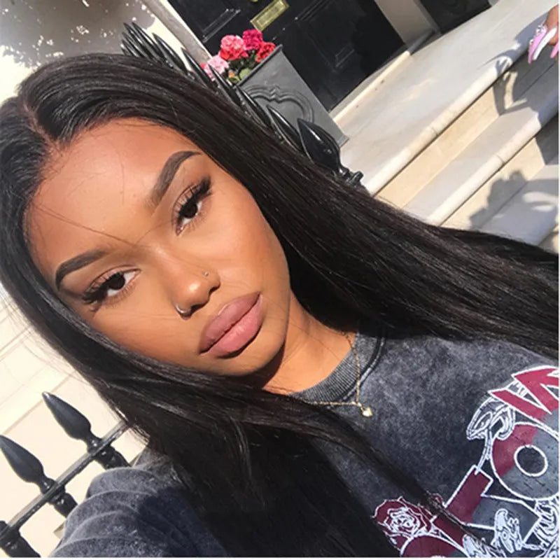 Long straight black synthetic wig with centre-parted bangs on a model