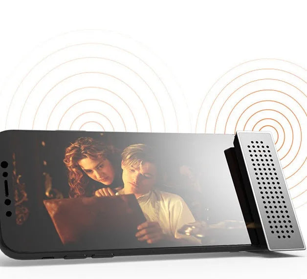 Mini black ABS plastic mobile phone amplifier bracket holding a smartphone on a desktop.