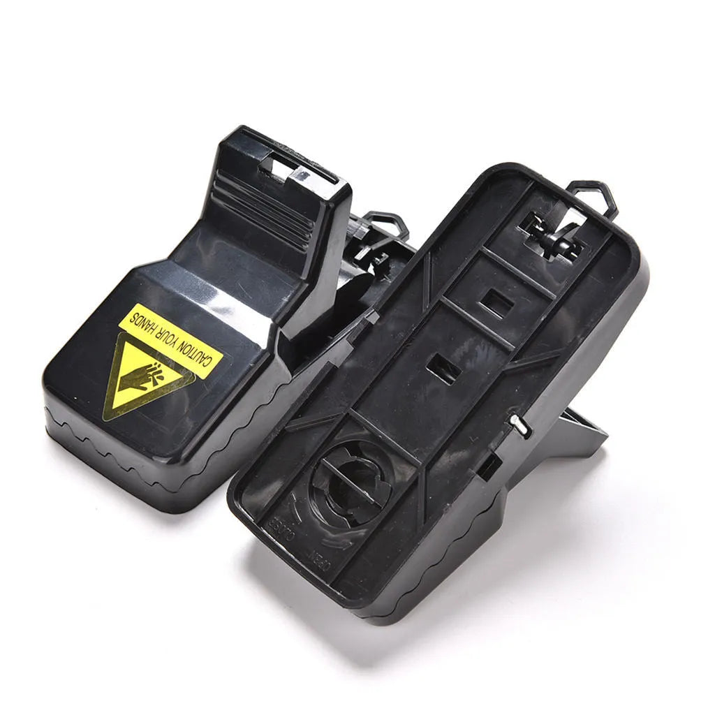Six black plastic snap mousetraps laid out, each measuring 11 cm long.