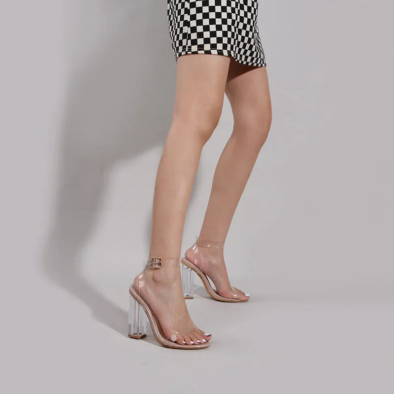 Women's apricot high-heel sandals with a glass heel and a buckle strap on a round toe.