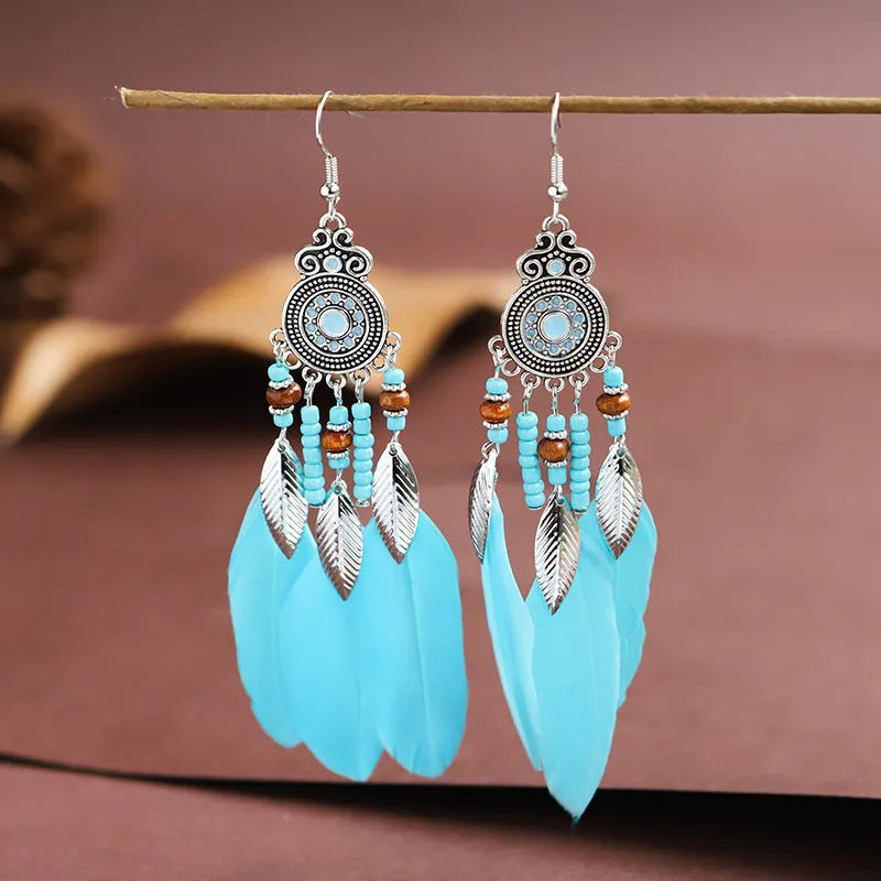 Feather-shaped round drop alloy earrings with leaf design in electroplated finish, showing Bohemian style jewellery.