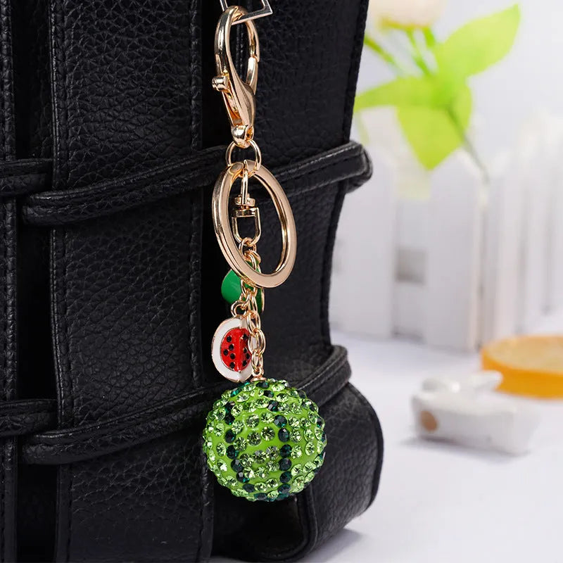 Green watermelon shaped zinc alloy keychain measuring 12cm with diamond detailing