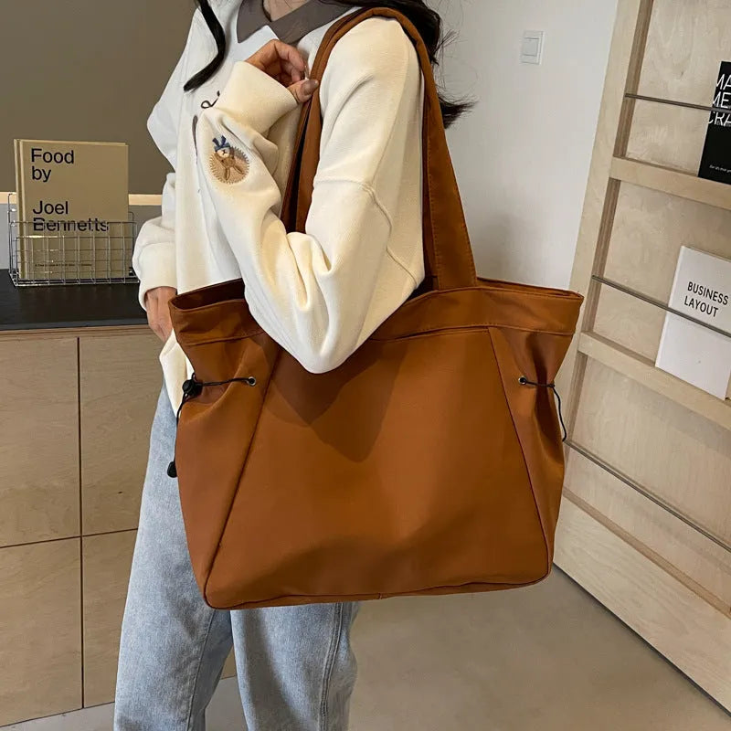Soft Oxford cloth folding commuter shoulder tote bag shown in light grey colour.