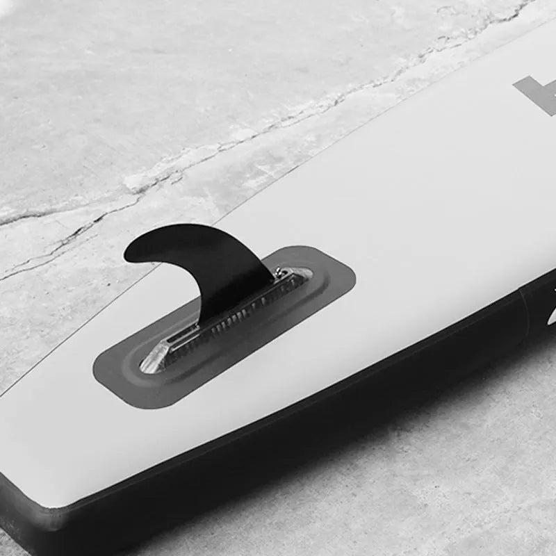 SUP paddle with large removable plastic fish fins attached via screw mechanism.