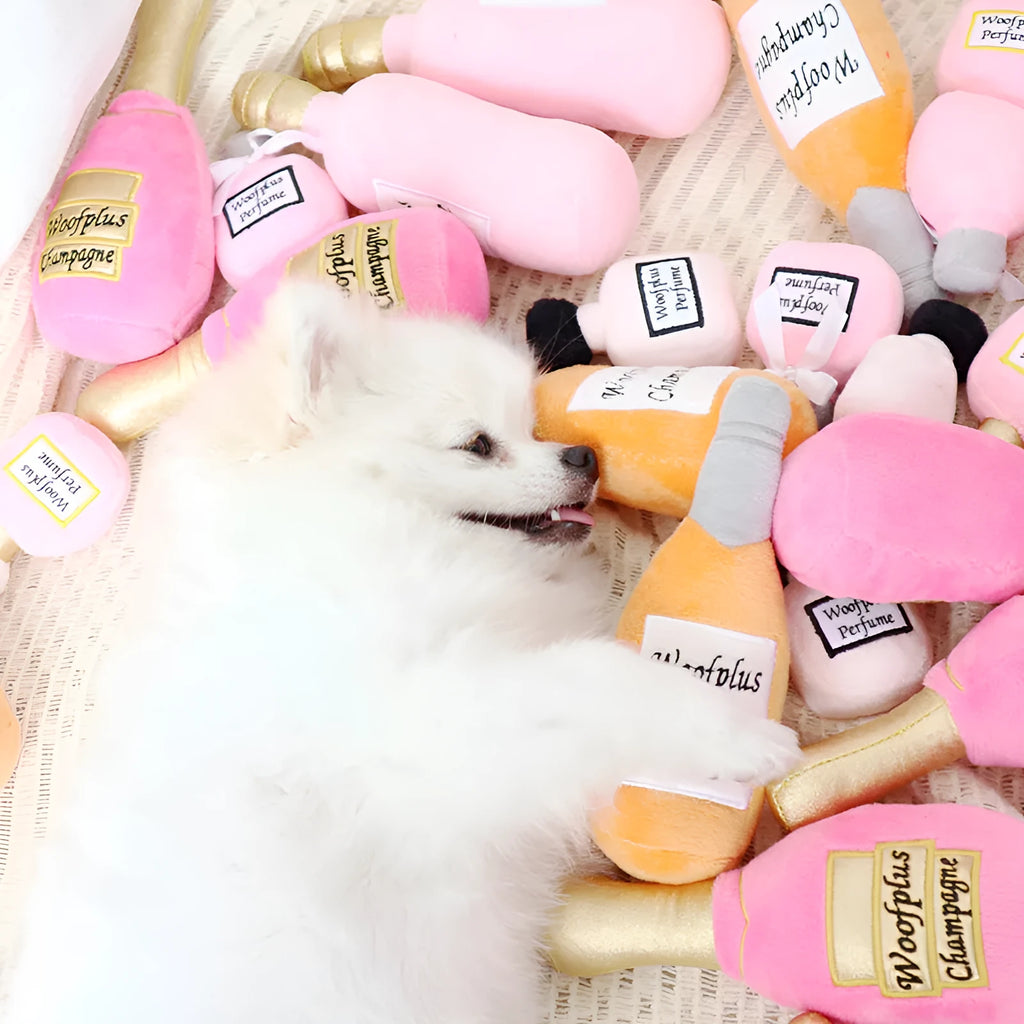 Soft plush pet toy shaped like a wine bottle, shown in various colours including green, red, and black.
