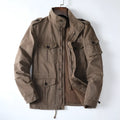 Man wearing a loose-fit light brown cotton twill retro jacket with a zip front.