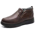 Men's black fleece-lined winter slip-on shoes with a non-slip rubber sole on a wooden floor.