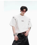 Black deconstructed short sleeve t-shirt with lace-up detail and a cutout design on a mannequin.