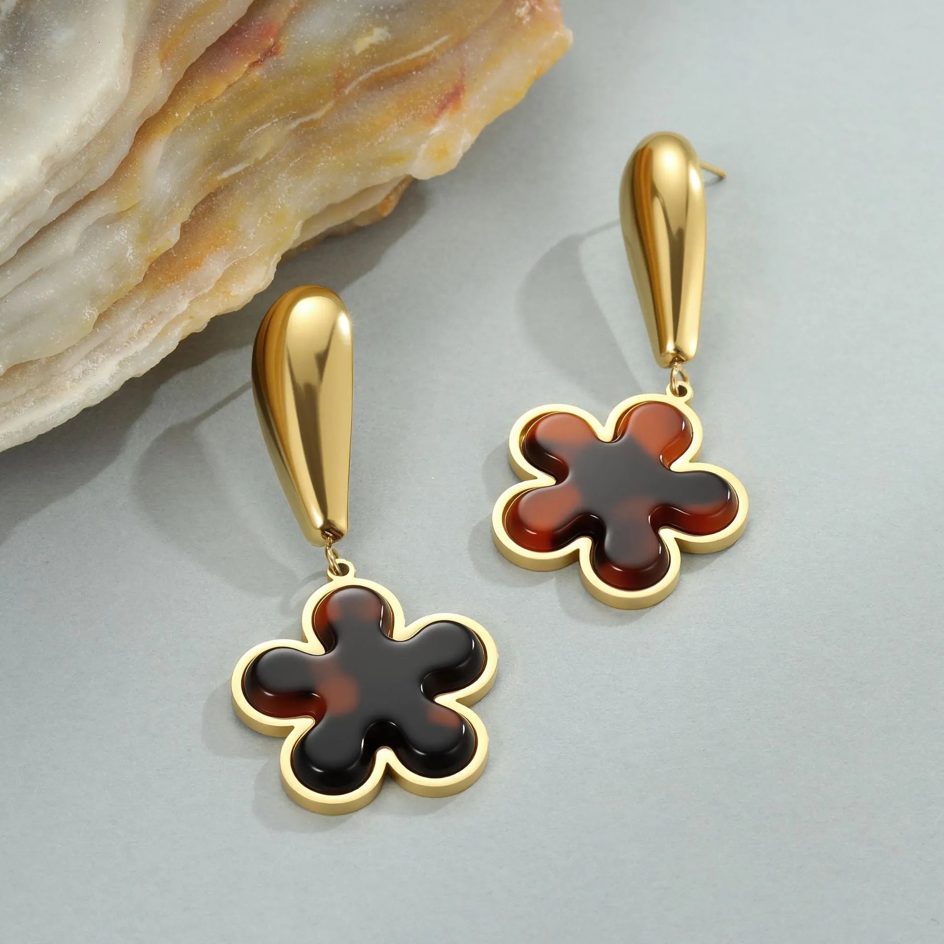Women's tortoiseshell colour earrings with 18K gold plating, showing heart-shaped and floral geometric designs on a stainless steel base.