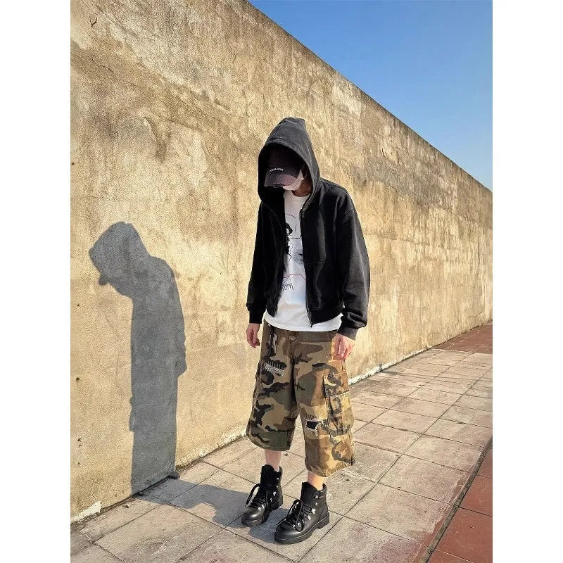Men's camouflage coloured cropped jeans with ripped detailing and retro patch accents