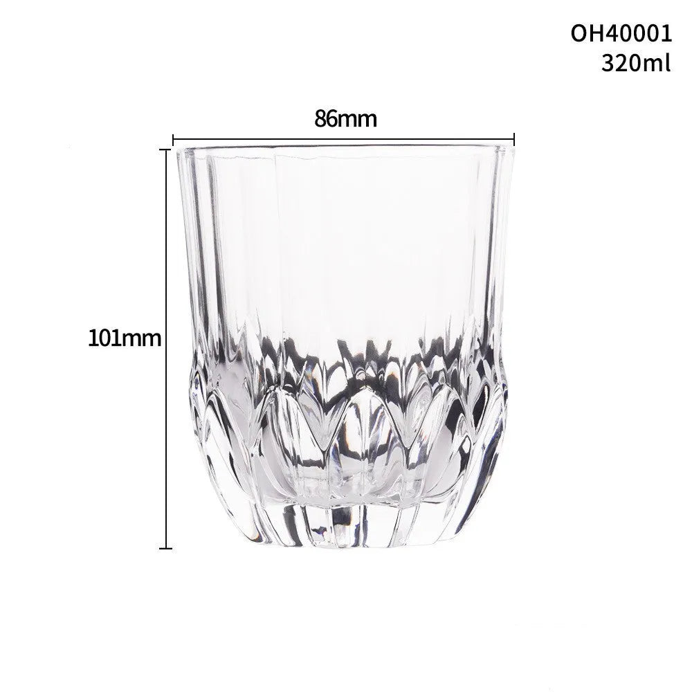 Clear crystal whiskey shot glass with a thick bottom base on a table.