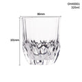 Clear crystal whiskey shot glass with a thick bottom base on a table.