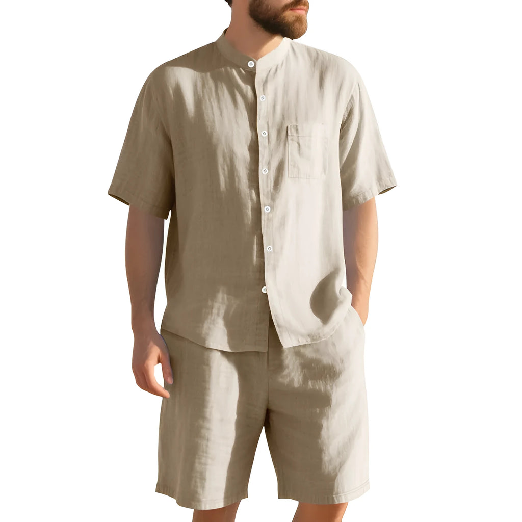 Men's light blue linen two-piece suit with short-sleeved henry collar shirt jacket and shorts on a hanger.