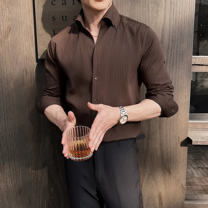 Man wearing a dark striped V-neck long sleeve shirt in a cardigan style.